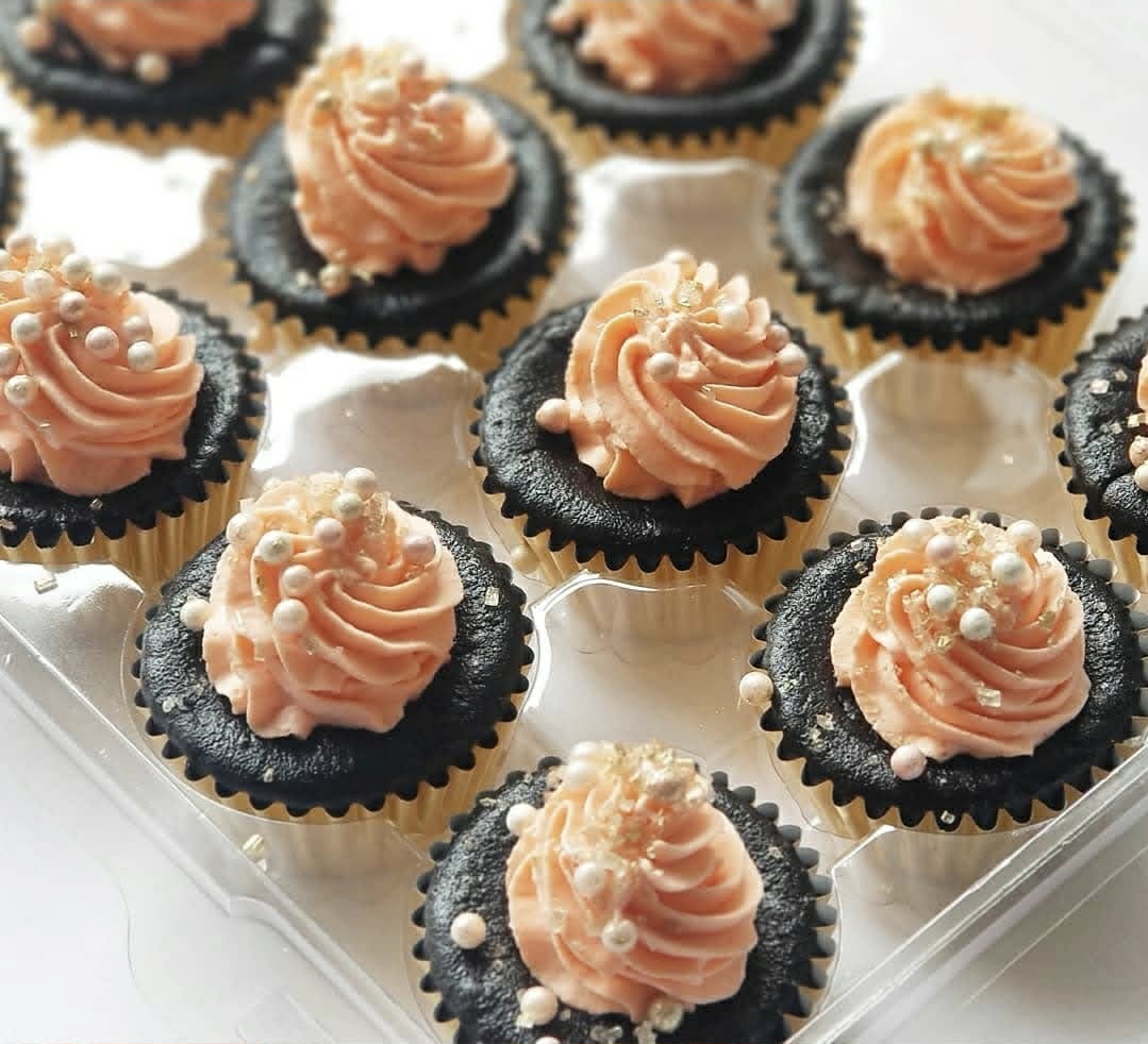 Decorated mini cheesecakes showing detailed piping work