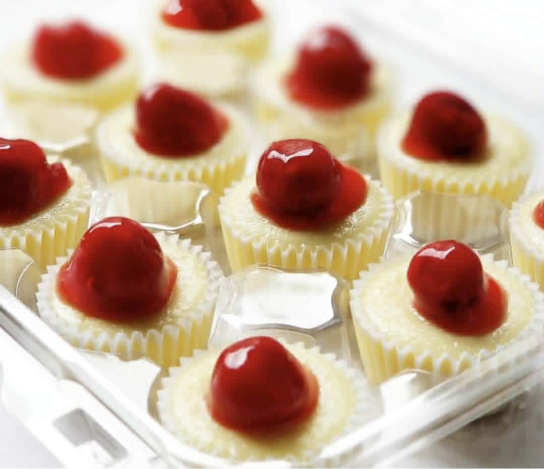 Original mini cheesecakes topped with cherries and fruit glaze